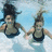 Two people in swimwear holding hands underwater with blue text on a cyan background.
