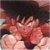 Pixelated static image of a figure with dark hair and light skin, wearing red clothing against a dark background.