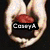 A hand holds a red and black object with 'Casey A' text overlay; the image is part of a