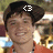 A pixelated image of a person with dark hair wearing an orange shirt, with text above the head changing from '<3' to 'I'd tap that'.