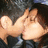 Pixelated image of two light-skinned hands clasped together against a dark, blurred background with hints of blue and brown tones.