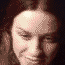 pixelated facial expressions showing a person's face in various states from neutral to exaggerated smiles and closed eyes, with dark background