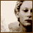 pixelated frames showing a woman's face with changing text overlays and glasses props, rendered in sepia tones