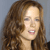 A static pixelated image of a person with long brown hair against a gray background, showing a partial face with closed eyes and a slightly open mouth.