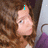 Pixelated image of a person with brown hair wearing purple clothing, showing text overlays in cyan pixel font across different frames.