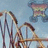 A pixelated roller coaster image with a small, colorful butterfly-like shape in the upper center against a light blue sky background.