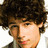 Pixelated image of a person with curly brown hair and light skin, with text fragments 'you', 'gotta', 'love em' in pixelated font.