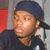 A person wearing a dark blue cap and black shirt appears in three showing slight head movement against a red and gray background
