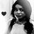 Black-and-white pixelated image of a person with long dark hair wearing a light-colored top, positioned next to a small solid black heart symbol on the left side.
