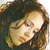 Pixelated close-up of a person's face with closed eyes, brown hair, and light skin tones against dark background.