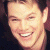A pixelated image of a smiling person with short dark hair on the left, next to green text reading 'Original Icons .com' on a solid green background.