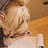 A pixelated image shows a person with blonde hair resting their head on another's shoulder, accompanied by blue text on a yellow background.