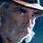 A 48x48 pixel animated contact sheet showing three sequential frames of a character with long hair, beard, and hat in different poses against blue and brown backgrounds.