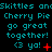 Pixelated cyan text on black background repeats 'Skittles anSkittles an' and 'Cherry Pie Cherry Pie Cherry Pie', with animated red symbols changing below.