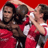 Static 48x48 pixel icon showing two figures in red sports uniforms embracing against a solid red background with visible pixelation and dithering effects.