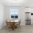 Pixelated static image of a room interior with a table, window, and furniture against light walls.