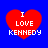 Four red heart shapes on a blue background, each containing white text reading "I LOVE KENNEDY" in pixelated font.