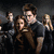 A pixelated image of a group scene with one person in the foreground, and text reading "Emma R80" at top right.