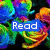 Pixelated image with vibrant multicolored background and two text overlays: 'Read' in blue and 'Thiiss!' in purple.