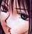 Pixelated close-up of a person's face with dark hair, visible eyes, and light skin tones in warm pinkish-brown hues.