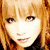 Pixelated image of a person with light brown hair and dark eyes, next to stylized orange text on a pink background.