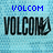 Blue text 'VOLCOM' and 'is' above large black 'VOLCOM' text with a hand gesture symbol on a light blue pixelated background.