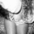 Black-and-white animated icon shows a person in a bikini top with long hair, legs visible, and a patterned background, with subtle motion in the hair and lower body.
