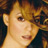 Pixelated close-up of a person's face with light brown hair and neutral expression against dark background.