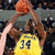 A pixelated image of a basketball player in yellow jersey with number 34 holding two orange basketballs, next to text listing names and numbers on a bright yellow background.