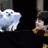 Pixelated static image of a white dog-like creature and partial figure with dark hair against black background, likely from early 2000s instant messaging platform.