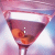 A martini glass filled with pink liquid and olives, displaying sequential text overlays in a