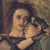 Pixelated image of two figures in close physical contact, one figure with dark hair and light skin, the other with dark hair and light skin, both in a dimly lit setting with muted brown and green tones.
