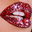 Pixelated close-up of lips with glossy red texture, white teeth visible between parted lips against light skin background.