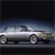 Pixelated image of a white sedan with dark wheels on a dark road under a gradient sky.