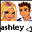 Pixelated image of two characters with blonde and brown hair, one wearing a blue-and-white striped shirt, below text reading 'ashley' in black block letters.