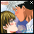 A 48x48 pixel animated buddy icon featuring two anime-style characters in a close embrace, with one character holding the other's face and both displaying blushing expressions against a light blue sky background.