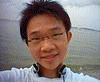 A person in a light blue shirt with dark collar trim appears in a of showing subtle facial expression changes against a blurred background
