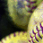 Pixelated image of a person in yellow clothing with purple accents, alongside text reading "Real Girls" and "PLAY SOFTBALL!" on black backgrounds.