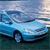 Pixelated blue car with dark wheels on a gradient background transitioning from light blue to dark green.