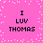 Pixelated pink background with white dots and four identical text blocks reading "I LUV THOMAS" in black block letters.