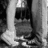 A static image of a person's lower legs and feet in a seated pose, with visible hands resting on the knees.