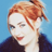 Static pixelated image of a person with red hair tied up, wearing dark clothing against a blue background.