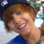 A four- shows a person with brown hair in different poses and expressions, wearing a blue shirt and dark cap with a white emblem