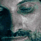 nine identical pixelated frames showing a man's face with a mustache and beard, eyes closed then open, in blue and gray tones