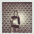 Pixelated static image of a dark rectangular object with a lighter square section against a mottled brown and gray background.