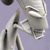Pixelated grayscale image of a figure with raised arm and open mouth against light purple background.