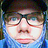 Pixelated static image of a person's face with closed eyes, dark hair, and light skin tone against blue background.