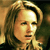 Pixelated close-up of a person with light brown hair, closed eyes, and a neutral expression against a blurred background.