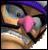 Pixelated image of a character with pink face, brown hair, and dark clothing against a multicolored background with blue, orange, and white tones.