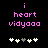 Pixelated pink text 'i heart vidyaaa' on black background with white and gray plus signs below, showing animation of the fourth plus sign changing color